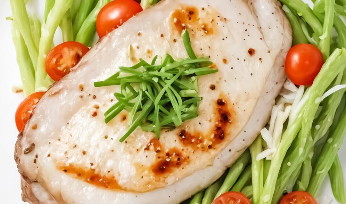 A close-up of a grilled pork chop on a white plate with green beans and cherry tomatoes. The pork chop is seasoned and cooked to perfection, with a crispy outer layer and a juicy inside. The green beans are steamed to a bright green, and the cherry tomatoes are plump and juicy. This image is perfect for use in cookbooks, food magazines, or restaurant menus.